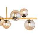 Lustre plafonnier Riha à 9 lampes en situation dans un salon moderne – Métal noir, laiton et verre ambre – Dakar, Sénégal.